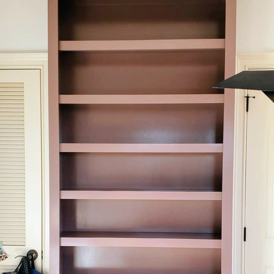 Floor-to-ceiling built-in bookshelf with crown molding