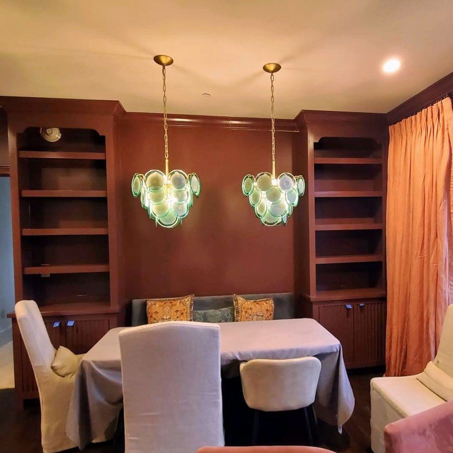 Built-in bookshelves and banquette seating in a dining nook, finished and styled